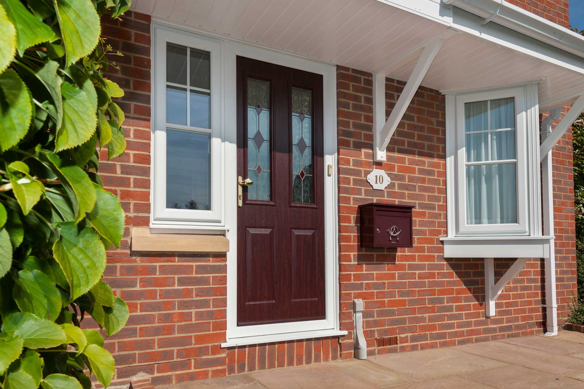 Warm brown uPVC Front Doors on an exposed red brick house in Carmarthen