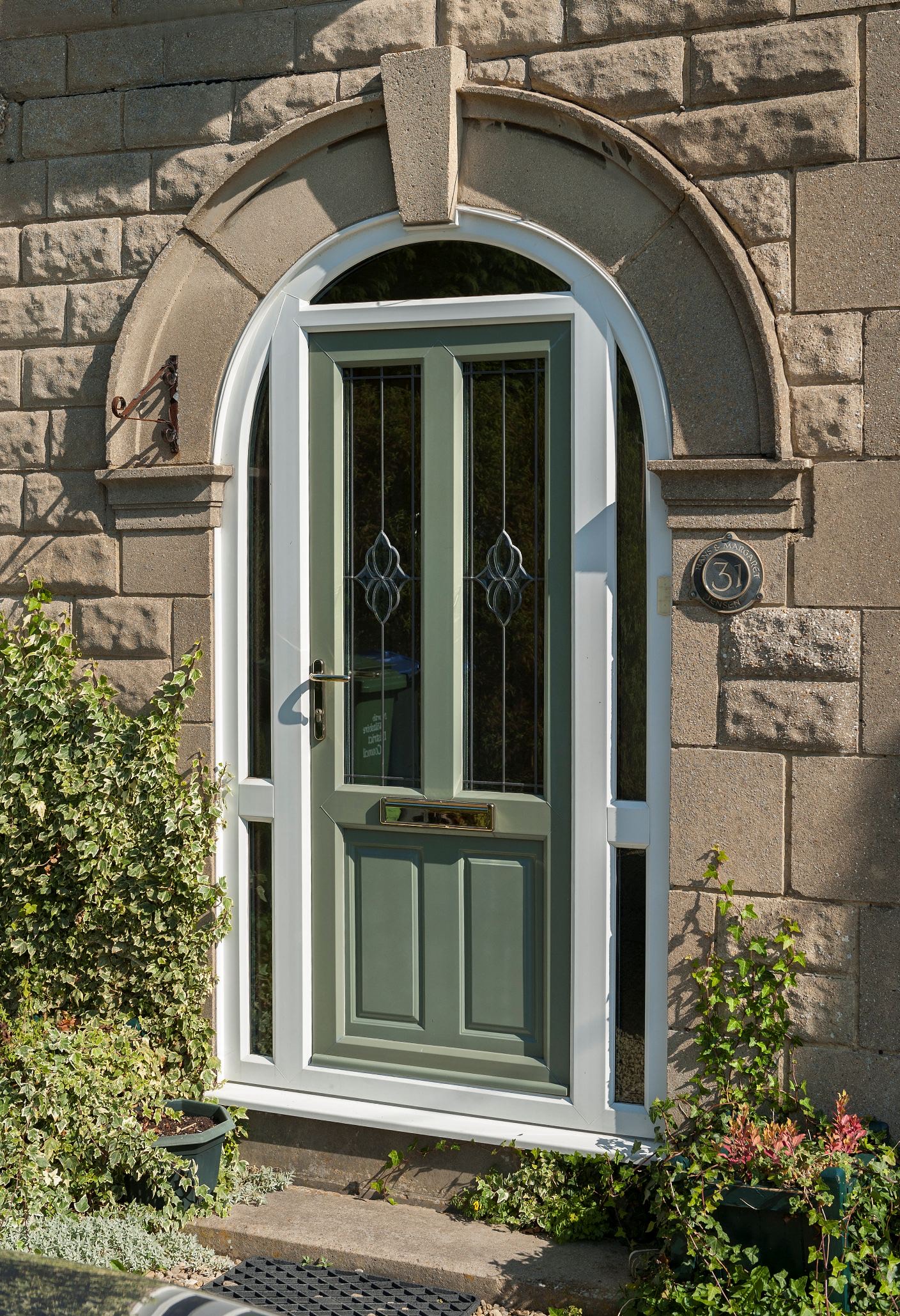 Light green uPVC front Door on a light brown stone building in Carmarthen