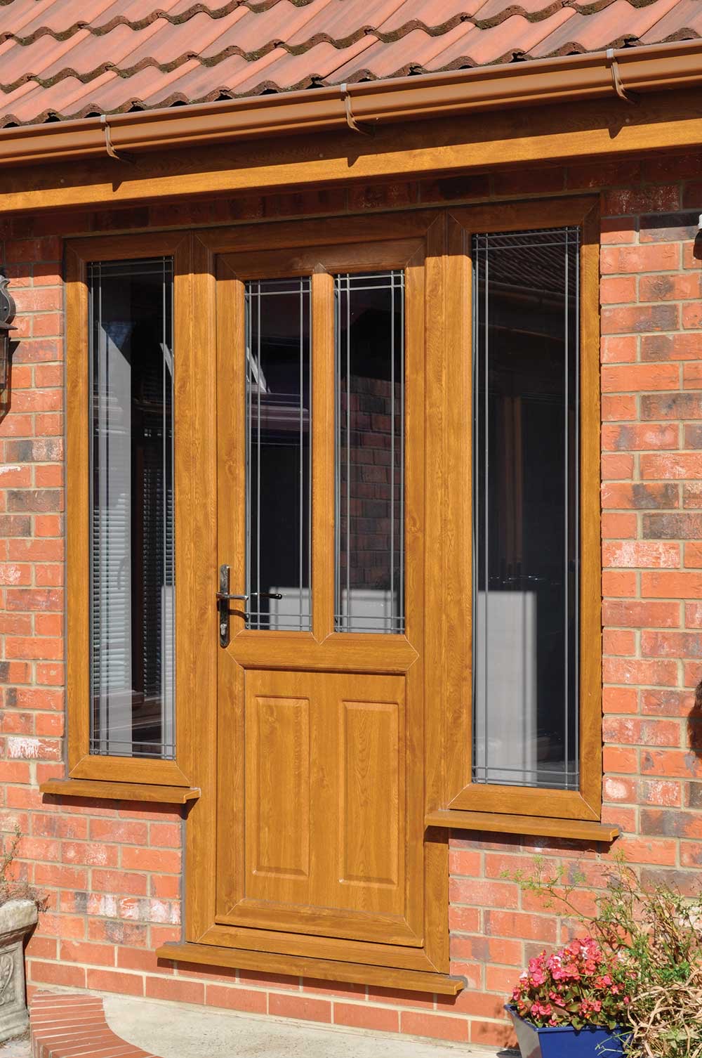 Light brown woodgrain foiled uPVC Residential Door on a red brick home in Carmarthen